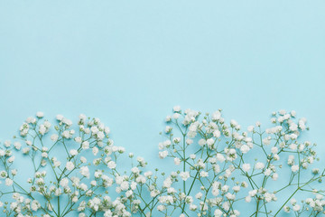 Wedding flower frame on blue table from above. Flat lay style.
