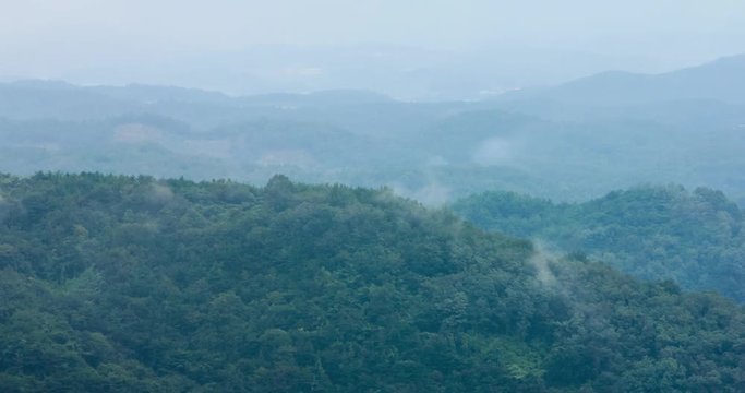 Gyeongsan, Korea Forested hillside of steam mist in Palgongsan mountain
