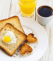 Egg fried in a heart-shaped toast cutout sprinkled