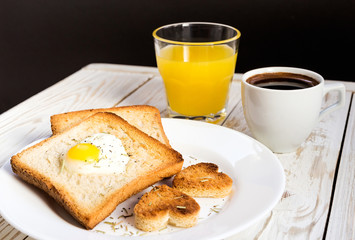 Egg fried in a heart-shaped toast cutout sprinkled