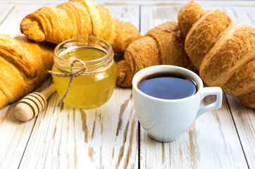 Fresh Croissants, honey and cup of espresso