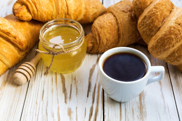 Fresh Croissants, honey and cup of espresso