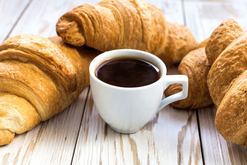 Fresh Croissants and cup of espresso. Selective focus