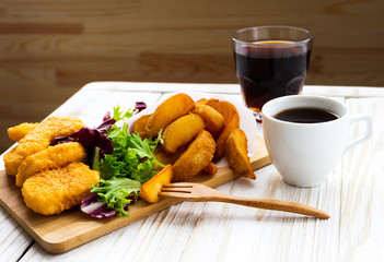 Greasy fried chicken, french fries, ketchup and salad.