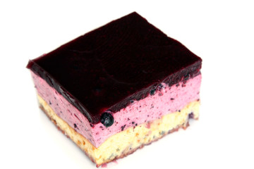 served dessert: isolated blueberry cheesecake with jelly on white plate