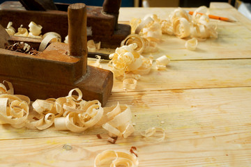 Carpenter tools on wood table background with sawdust. Copy space
