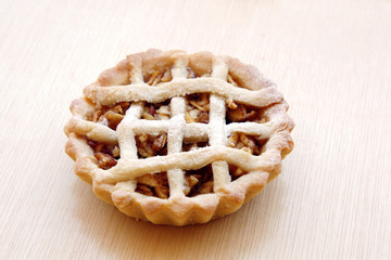 close-up homemade delicious apple tartlet on wooden background with copy space