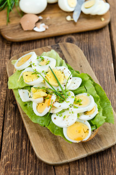 Old wooden table with sliced Eggs