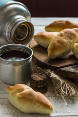 Russian pirozhki ,baked patties, on wooden cutboard