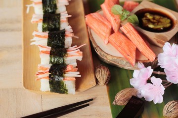 Sushi crab stick with wasabi and sauce.