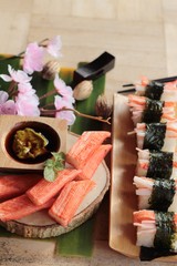 Sushi crab stick with wasabi and sauce.