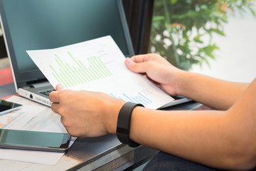 Businessman working by laptop with tablet and smartphone and doc