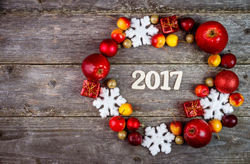 Christmas Decoration Over Wooden Background and fruits. Xmas card and gift. Winter holidays theme. Empty space for text. Top view.