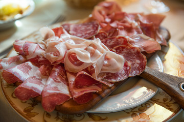 Typical various italian salami, servided on plate at restaurant.