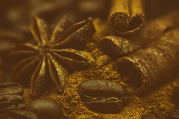 Background with many coffee beans. The effect of film grain. Cinnamon and star anise.