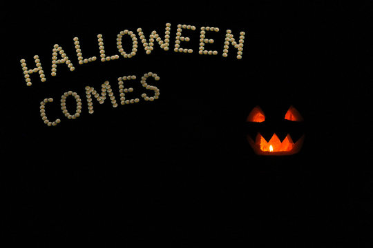 fabulous pumpkins and inscription Halloween in the darkness