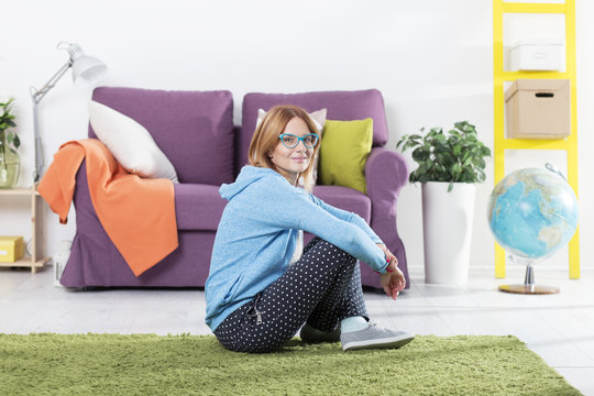 Young Red Hair Woman Sitting On The Floor In Living Room