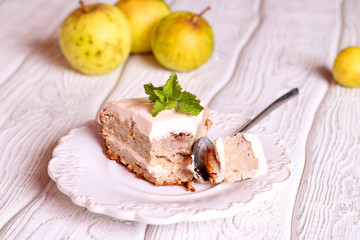 A slice of apple pie on a plate with cream