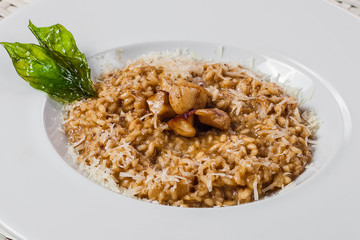 risotto with cheese and vegetables on a white plate