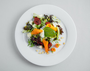 Vegetarian salad on a white plate. View from above