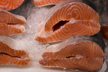 Fresh trout on ice in a supermarket. Slice of Fresh salmon in a fish shop.