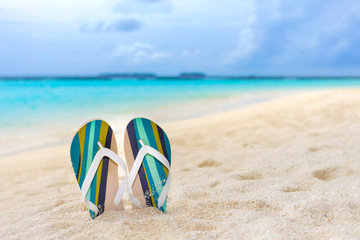 Fototapeta na wymiar Beach slippers in the sand at Maldives