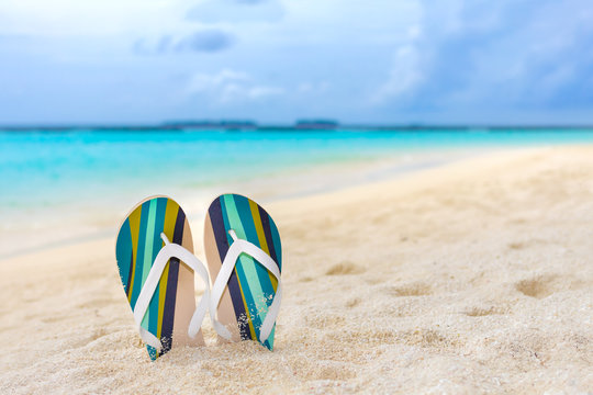 Beach slippers in the sand at Maldives