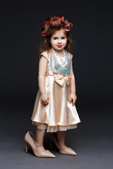 Cute little girl in dress and high heels