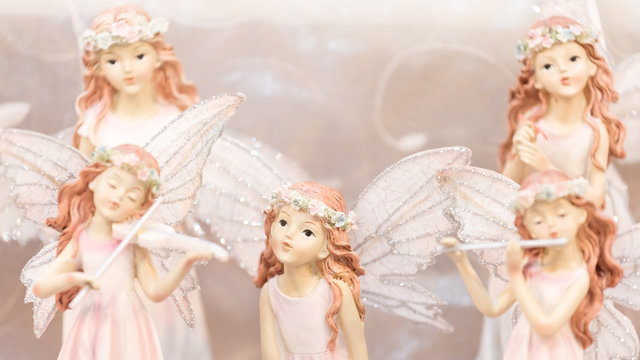 selective focus (only the middle one) of pink fairy angel figure