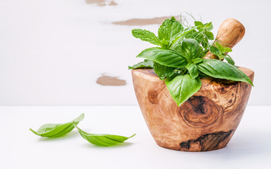 Alternative medicine fresh herbs in the wooden mortar . Food ing