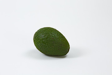 Avacado alone on white background stem to the right