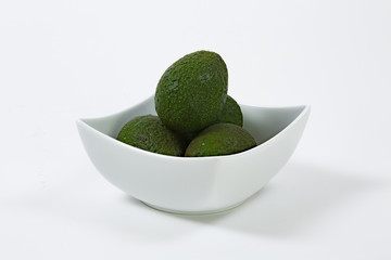 Avacado in white bowl group with white background full frame