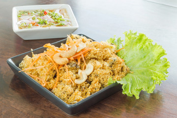 Salad fried catfish thai food on wood table
