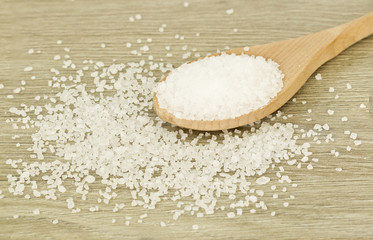 Fototapeta na wymiar Wooden spoon of coarse salt