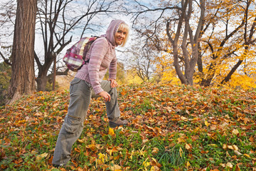 Happy senior female hiker enjoying outdoor activity
