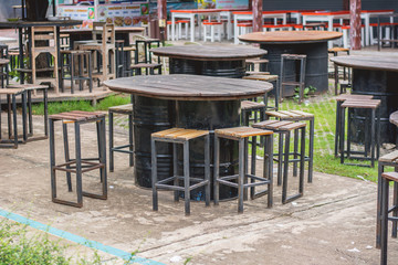 Wooden tables made from barrels.