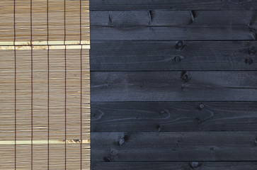 Bamboo mat on wooden table, top view