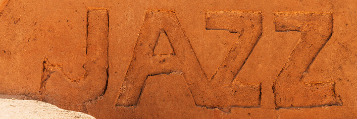 The word Jazz photographed in sand on the beach
