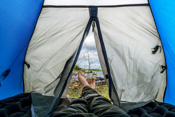 Man lying in tent in  camping in the summer