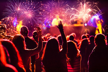 New Year concept - cheering crowd and fireworks