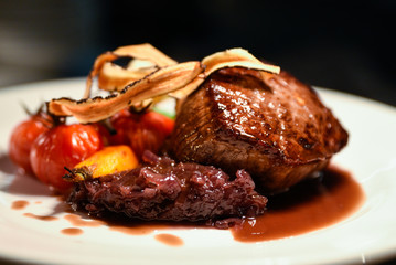 Freshly made thick and juicy grilled steak prepared with tomatoes paprika and onions complimented...