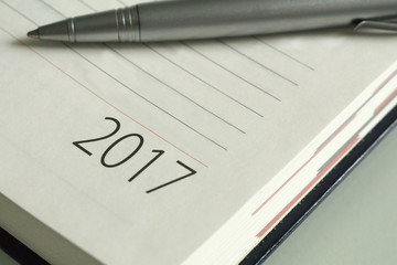 New Year 2017 office organizer calendar and sliver ballpen. Selective focus