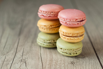 Colorful macaroons over turquoise wood backround