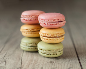 Colorful macaroons over turquoise wood backround