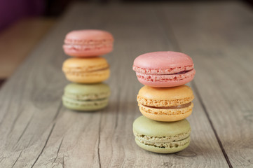 Colorful macaroons over turquoise wood backround