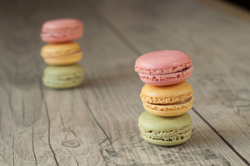 Colorful macaroons over turquoise wood backround