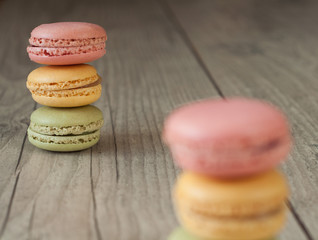Colorful macaroons over turquoise wood backround