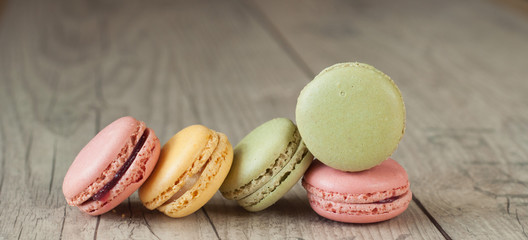 Colorful macaroons over turquoise wood backround