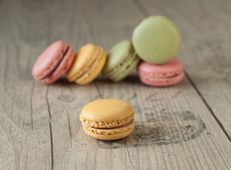 Colorful macaroons over turquoise wood backround