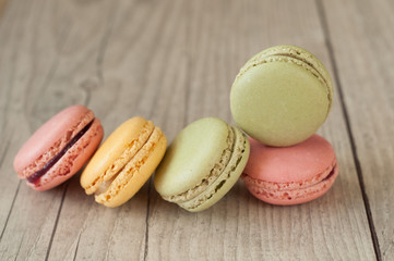 Colorful macaroons over turquoise wood backround